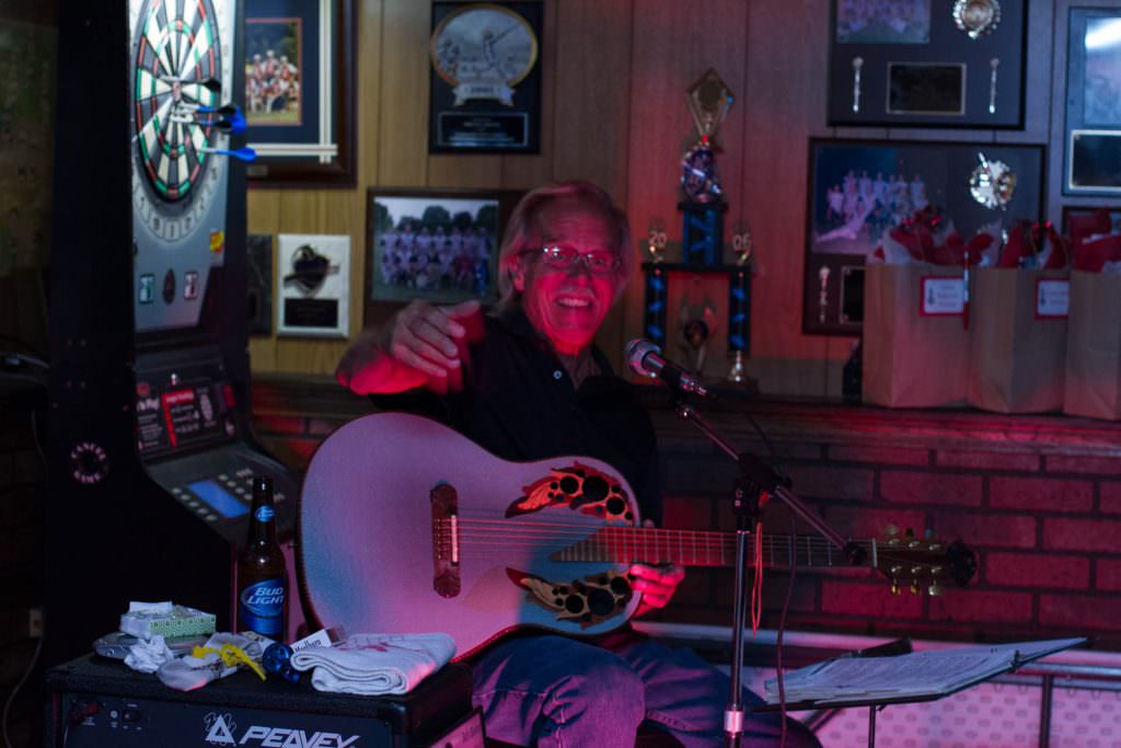 Musician with an Ovation guitar, Peavey amp and a pack of cigarettes