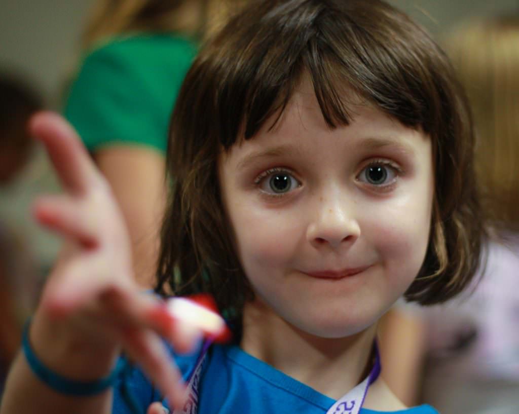 A young girl reaches out to the world in a 50mm portrait